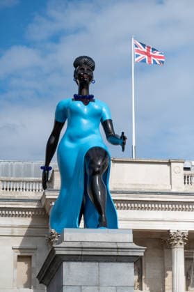 September 12, 2026, London, United Kingdom: Sculpture Lady in Blue with the British Flag in the background in Trafalgar Square, London. Lady in Blue, a bronze sculpture by New York-based artist Tschabalala Self, stands on the Fourth Plinth in Trafalgar Square, London. Unveiled on 10 September, the work pays homage to a young metropolitan woman of colour and was created as a contemporary everywoman representing the diversity of London today. The sculpture explores themes of representation, recognition and equity, presenting an everyday woman walking forward into a shared future rather than a traditional historical figure or monument. The bronze sculpture is patinated in Lapis Lazuli blue, a pigment with a long history across North Afri - ZUMAs197 20260912_aaa_s197_278 Copyright: xAndreaxDomeniconix