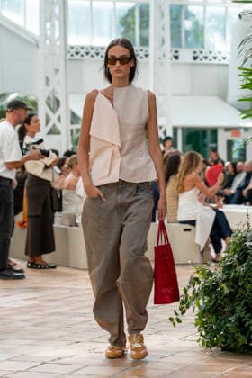 Models present creations from Adolfo Dominguez s Croma collection for spring-summer 2027 during Mercedes-Benz Fashion Week Madrid. Under the creative direction of Tiziana Domínguez, the Galician label, marking its 50th anniversary, remained faithful to its signature codes, showing pronounced asymmetry, scarves worked into both menswear and womenswear, sequins and textile appliques, alongside organic cotton denim dyed in tangerine tones and mini-pleated men s trousers. September 14,2026. (20260914828)