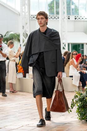 Models present creations from Adolfo Dominguez s Croma collection for spring-summer 2027 during Mercedes-Benz Fashion Week Madrid. Under the creative direction of Tiziana Domínguez, the Galician label, marking its 50th anniversary, remained faithful to its signature codes, showing pronounced asymmetry, scarves worked into both menswear and womenswear, sequins and textile appliques, alongside organic cotton denim dyed in tangerine tones and mini-pleated men s trousers. September 14,2026. (20260914911)