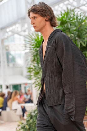 Models present creations from Adolfo Dominguez s Croma collection for spring-summer 2027 during Mercedes-Benz Fashion Week Madrid. Under the creative direction of Tiziana Domínguez, the Galician label, marking its 50th anniversary, remained faithful to its signature codes, showing pronounced asymmetry, scarves worked into both menswear and womenswear, sequins and textile appliques, alongside organic cotton denim dyed in tangerine tones and mini-pleated men s trousers. September 14,2026. (20260914973)
