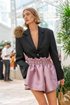 Models present creations from Adolfo Dominguez s Croma collection for spring-summer 2027 during Mercedes-Benz Fashion Week Madrid. Under the creative direction of Tiziana Domínguez, the Galician label, marking its 50th anniversary, remained faithful to its signature codes, showing pronounced asymmetry, scarves worked into both menswear and womenswear, sequins and textile appliques, alongside organic cotton denim dyed in tangerine tones and mini-pleated men s trousers. September 14,2026. (20260914979)