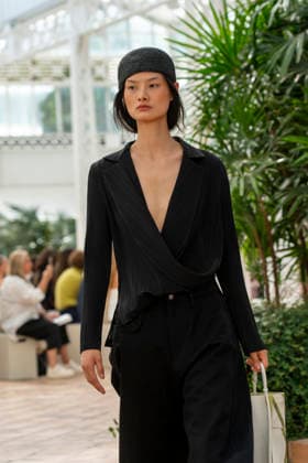 Models present creations from Adolfo Dominguez s Croma collection for spring-summer 2027 during Mercedes-Benz Fashion Week Madrid. Under the creative direction of Tiziana Domínguez, the Galician label, marking its 50th anniversary, remained faithful to its signature codes, showing pronounced asymmetry, scarves worked into both menswear and womenswear, sequins and textile appliques, alongside organic cotton denim dyed in tangerine tones and mini-pleated men s trousers. September 14,2026. (20260914857)