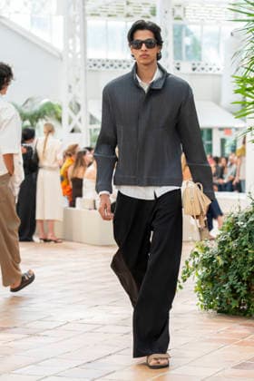 Models present creations from Adolfo Dominguez s Croma collection for spring-summer 2027 during Mercedes-Benz Fashion Week Madrid. Under the creative direction of Tiziana Domínguez, the Galician label, marking its 50th anniversary, remained faithful to its signature codes, showing pronounced asymmetry, scarves worked into both menswear and womenswear, sequins and textile appliques, alongside organic cotton denim dyed in tangerine tones and mini-pleated men s trousers. September 14,2026. (20260914896)