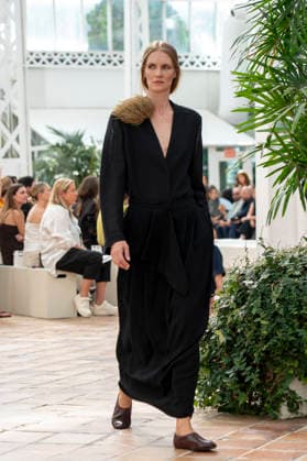 Models present creations from Adolfo Dominguez s Croma collection for spring-summer 2027 during Mercedes-Benz Fashion Week Madrid. Under the creative direction of Tiziana Domínguez, the Galician label, marking its 50th anniversary, remained faithful to its signature codes, showing pronounced asymmetry, scarves worked into both menswear and womenswear, sequins and textile appliques, alongside organic cotton denim dyed in tangerine tones and mini-pleated men s trousers. September 14,2026. (20260914932)