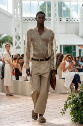 Models present creations from Adolfo Dominguez s Croma collection for spring-summer 2027 during Mercedes-Benz Fashion Week Madrid. Under the creative direction of Tiziana Domínguez, the Galician label, marking its 50th anniversary, remained faithful to its signature codes, showing pronounced asymmetry, scarves worked into both menswear and womenswear, sequins and textile appliques, alongside organic cotton denim dyed in tangerine tones and mini-pleated men s trousers. September 14,2026. (20260914937)
