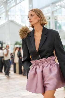 Models present creations from Adolfo Dominguez s Croma collection for spring-summer 2027 during Mercedes-Benz Fashion Week Madrid. Under the creative direction of Tiziana Domínguez, the Galician label, marking its 50th anniversary, remained faithful to its signature codes, showing pronounced asymmetry, scarves worked into both menswear and womenswear, sequins and textile appliques, alongside organic cotton denim dyed in tangerine tones and mini-pleated men s trousers. September 14,2026. (20260914982)