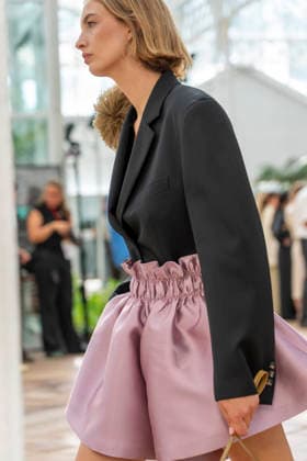 Models present creations from Adolfo Dominguez s Croma collection for spring-summer 2027 during Mercedes-Benz Fashion Week Madrid. Under the creative direction of Tiziana Domínguez, the Galician label, marking its 50th anniversary, remained faithful to its signature codes, showing pronounced asymmetry, scarves worked into both menswear and womenswear, sequins and textile appliques, alongside organic cotton denim dyed in tangerine tones and mini-pleated men s trousers. September 14,2026. (20260914984)