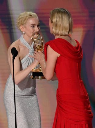 Rhea Seehorn (R) accepts the Outstanding Lead Actress in a Drama Series Award for Pluribus from Julia Garner on stage during the 78th annual Primetime Emmy Awards at the Peacock Theater in Los Angeles on Monday, September 14, 2026.  LAP2026091468 JIMxRUYMEN