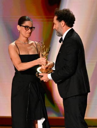Matthew Rhys accepts the Outstanding Lead Actor in a Comedy Series Award for Widow s Bay from Amanda Peet on stage during the 78th annual Primetime Emmy Awards at the Peacock Theater in Los Angeles on Monday, September 14, 2026.  LAP20260914112 JIMxRUYMEN
