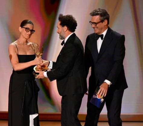 Matthew Rhys accepts the Outstanding Lead Actor in a Comedy Series Award for Widow s Bay from Amanda Peet and Jon Hamm on stage during the 78th annual Primetime Emmy Awards at the Peacock Theater in Los Angeles on Monday, September 14, 2026.  LAP20260914111 JIMxRUYMEN