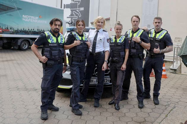 ABB HAFENKANTE Zejhun Demirov, Lilli Hollunder, Sanna Englund, Rhea Harder Vennewald, Matthias Schloo, Marc Barthel, actors in police uniforms at a photo op marking the premiere of the 20th anniversary season and the 500th episode of the ZDF TV series *Notruf Hafenkante* on the original set of PK 21 at Studio Hamburg on September 16, 2026, in Hamburg