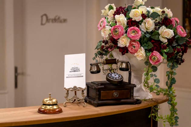 September 16, 2026, ARD telenovela *STURM DER LIEBE*, photo shoot for Season 23 on the film set in Munich, at Bavaria Film in Geiselgasteig, in the studio set of the fictional Hotel Fürstenhof reception area with a telephone and doorbell, September 16, 2026, ARD series *Sturm der Liebe* September 16, 2026, ARD series *Sturm der Liebe*