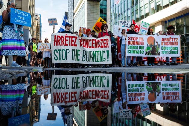 September 19, 2026, Ottawa, On, Canada: Demonstrators are reflected in a puddle during a climate march in Ottawa, on Saturday, Sept. 19, 2026. Ottawa Canada  - ZUMAc35_ 20260919_zaf_c35_013 Copyright: xKeitoxNewmanx