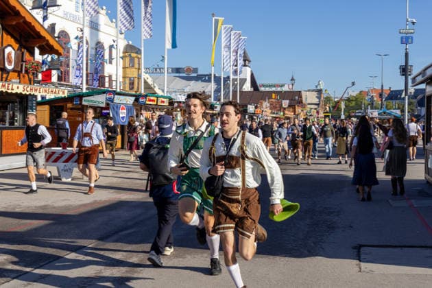 Munich, Bavaria, Germany September 19, 2026: On the opening morning of the 191st Oktoberfest in 2026, visitors rush toward the festival tents. At 9:00 a.m. sharp, the rush for coveted seats begins three hours before the official tapping of the first keg