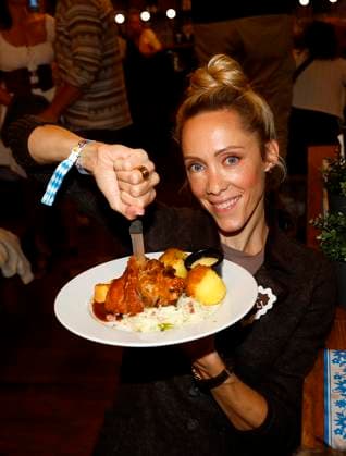 Melanie Wolf O™ is the second to tap the keg with Frank Zander at the Oktoberfest at the Hofbräuhaus Berlin