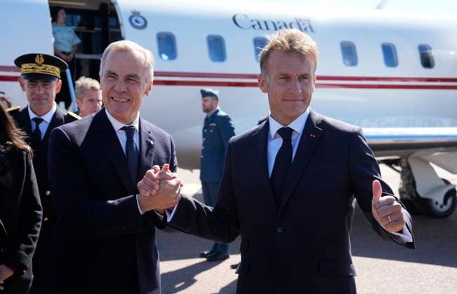 September 20, 2026, Saint-Pierre, France: French President Emmanuel Macron, right, greets ..Prime Minister Mark Carney as he arrives in Saint-Pierre, Saint-Pierre-et-Miquelon, a French territory 20 kilometres off the southern coast of Newfoundland, on Sunday, Sept. 20, 2026. Saint-Pierre France - ZUMAc35_ 20260920_zaf_c35_006 Copyright: xAdrianxWyldx