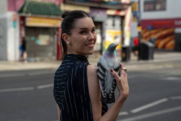 September 20, 2026, London, Camden, United Kingdom: An attendee arrives wearing a black dress and carrying a plastic pigeon at the Erdem catwalk show, held at the Roundhouse in Camden, London, as part of London Fashion Week 2026. Models and members of the fashion industry gather at the Roundhouse in Camden, London, for the Erdem catwalk show during London Fashion Week 2026. The event forms part of the official London Fashion Week schedule, bringing together models, designers, fashion professionals, media and guests for the presentation of Erdem s latest collection. London United Kingdom - ZUMAs197 20260920_aaa_s197_349 Copyright: xJamesxWilloughbyx
