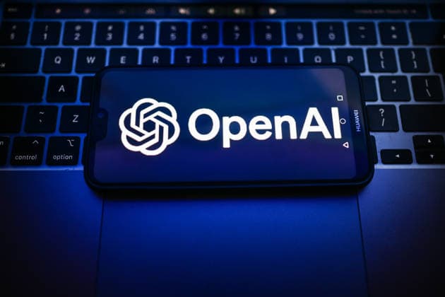 Tech illustrations in Poland - 25 Sept 2026 In this photo illustration, an OpenAI logo is seen displayed on a smartphone on the top of a laptop. Poland Copyright: xOmarxMarquesx xSOPAxImagesx omarques_25092026_TECHPOL-13
