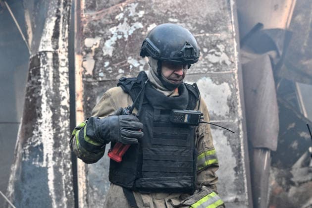 A State Emergency Service rescuer stands in front of damaged retail pavilions after the main hotspots of a fire were extinguished at the Central Clothes Market (Anholenko) in Zaporizhzhia, Ukraine, September 26, 2026. The market sustained significant damage in a Russian drone attack. (Photo by Dmytro Smolienko Ukrinform) Russian troops strike clothes market in Zaporizhzhia  Copyright: xDmytroxSmolienkox