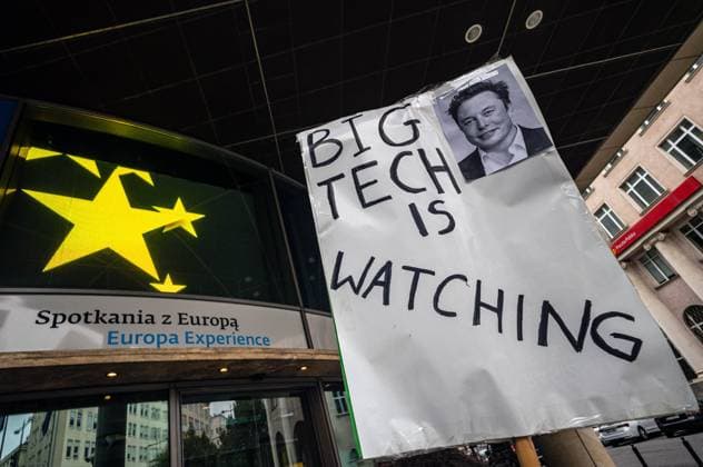 September 26, 2026, Warsaw, Mazovia, Poland: A placard that says Big Tech Is Watching next to a picture of Elon Musk is seen in front of the European Union building..Left-wing antifascist activists gather outside the European Union Commission building in Warsaw to protest against the Chat Control 1.0 legislation recently revived by the European Parliament. The legislation allows for the mass scanning of messages belonging to every European Union citizen for Child Sexual Abuse Material (CSAM) in the name of protecting children s rights and combating pedophilia. The activists, however, believe rights to privacy and the foundations of free speech are being trampled upon, especially with talks due to resume regarding the far more dangerous - ZUMAs197 20260926_aaa_s197_187 Copyright: xNeilxMiltonx