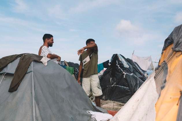 September 26, 2026, Ceuta, Ceuta, Spain: Migrants stand among tents and makeshift shelters at an informal settlement on the coast of Ceuta. Thousands of migrants, most of them young Moroccan men, have been living in makeshift settlements in the Spanish North African enclave of Ceuta since a mass arrival at the end of July 2026 set off a migration and political crisis. Ceuta Spain - ZUMAs392 20260926_zip_s392_002 Copyright: xFabianxSuspensivox