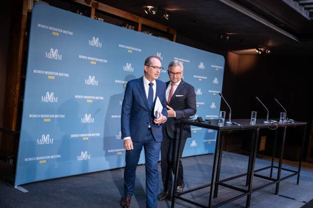 Alexander Dobrindt, German Federal Minister of the Interior and host of the meeting, walking alongside Magnus Brunner, EU Commissioner for Home Affairs and Migration (on the left), during their joint press statement at the start of the 2nd Munich Migration Meeting—a gathering of European ministers to discuss the implementation of the migration policy shif