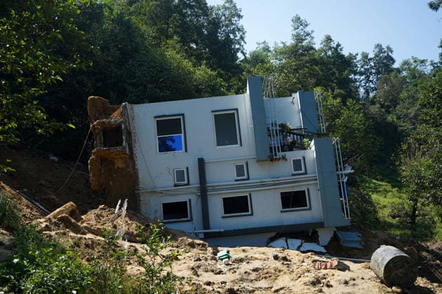September 28, 2026, Kathmandu, Bagmati, Nepal: People stand and watch near a house that collapsed due to a landslide in Lalitpur, Nepal, on September 28, 2026. Nepal has experienced numerous floods and landslides following continuous rainfall over the past four days. Kathmandu Nepal  - ZUMAd164 20260928_zip_d164_007 Copyright: xAryanxDhimalx