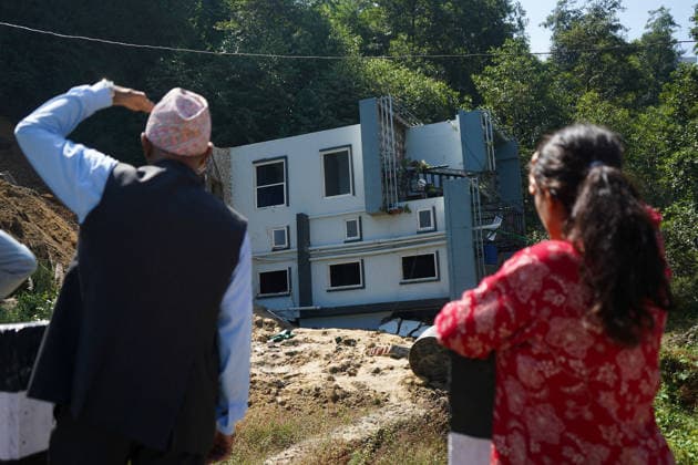 September 28, 2026, Kathmandu, Bagmati, Nepal: People stand and watch near a house that collapsed due to a landslide in Lalitpur, Nepal, on September 28, 2026. Nepal has experienced numerous floods and landslides following continuous rainfall over the past four days. Kathmandu Nepal  - ZUMAd164 20260928_zip_d164_008 Copyright: xAryanxDhimalx