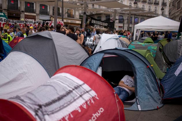 September 28, 2026, Madrid, Madrid, Spain: A young man with his mobile phone in hand sits inside his tent in the Puerta del Sol square in central Madrid, during a protest camp against the high cost of housing and rent in Spain. The protest arose following the eviction of an 87-year-old woman from her apartment in Madrid. Madrid Spain - ZUMAs296 20260928_znp_s296_004 Copyright: xLuisxSotox