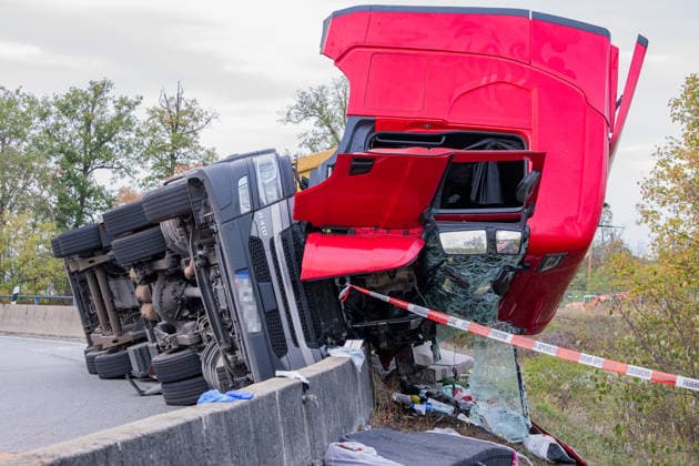 LKW kippt auf Autobahnverbindung um Zugmaschine hängt über Böschung Am 28.09.2026 kam es gegen 17:50 Uhr in Frankfurt am Main auf der A3 am Frankfurter Kreuz, auf der Verbindungsspur zur A5 in Richtung Darmstadt, zu einem schweren Unfall eines LKW-Sattelschleppers. Der mit einem 40-Fuß-Container beladene Lastzug geriet aus bislang unbekannter Ursache gegen die Betonschutzplanke und kippte auf die Seite, wobei die Zugmaschine erheblich beschädigt wurde und über die Böschung hing. Der Fahrer wurde leicht verletzt und in eine Klinik gebracht. Aus dem Fahrzeug ausgelaufene Betriebsmittel wurden von der Feuerwehr mit Bindemittel von der Fahrbahn entfernt. Die Bergungsarbeiten dauern an, die Auffahrt von der A3 auf die A5 in Richtung D