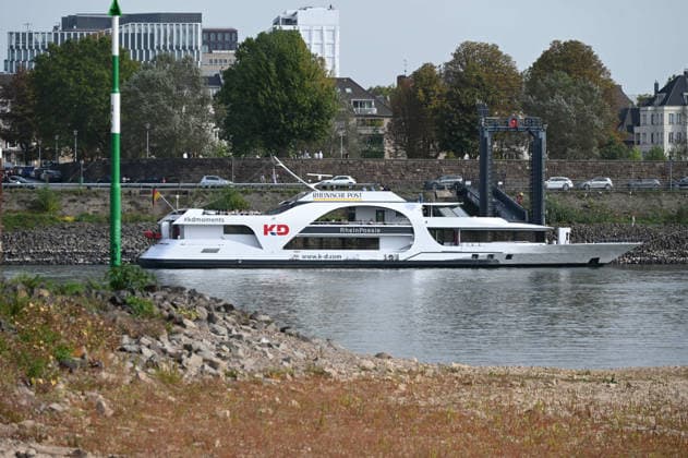Low water levels in the Rhine have exposed a large sandbar; rocks and sand on the riverbank near the Theodor Heuss Bridge, with the passenger ship Rheinpoesie in the background. Low water levels in the Rhine near Düsseldorf, Düsseldorf, September 28, 2026,