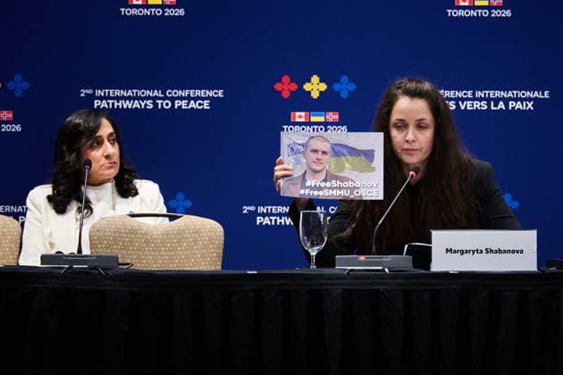 September 28, 2026, Toronto, On, Canada: Minister of Foreign Affairs Anita Anand, left, looks on as Margaryta Shabanova holds up a photo of her husband, a member of the Ukrainian forces who has been held in Russian captivity since 2021, as she speaks at the Pathways to Peace conference on the return of Ukrainian children held by Russian officials in Toronto, on Monday, Sept. 28, 2026. Toronto Canada  - ZUMAc35_ 20260928_zaf_c35_145 Copyright: xSammyxKoganx