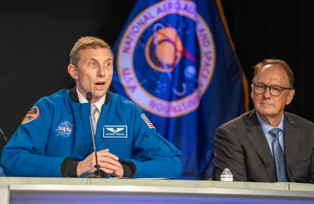 NASA astronaut Woody Hoburg and Boeing Commercial Crew Program Manager John Mulholland (R) make comments on the Boeing Starliner Spacecraft at a news conference at Kennedy Space Center, Florida on Monday, September 28, 2026. The backdrop is a photo of the International Space Station, where the Starliner was designed to fly to but has had troubles. After a redesign, the next Starliner is expected to be launched in December.  KSC20260928118 PATxBENIC