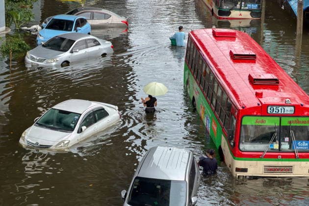September 28, 2026, Bangkok, Bangkok, Thailand: A woman with an umbrella wading through water among stranded vehicles on Lat Phrao Road in Bangkapi, one of the most flooded areas in Bangkok since an active low-pressure system and monsoon have dumped nearly 300 millimetres (11.8 inches) of rain since the afternoon of September 24. Bangkok authorities have officially declared all 50 districts of the Thai capital as flood disaster areas following four straight days of severe rainfall. Bangkok Thailand  - ZUMAkok, 20260928_zip_w151_026 Copyright: xPatrickxChengzhixWangx