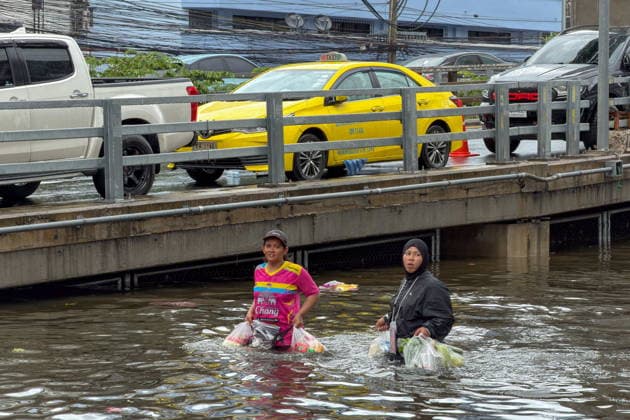 September 28, 2026, Bangkok, Bangkok, Thailand: Two women with a few bags wading through waist-level water on Lat Phrao Road in Bangkapi, one of the most flooded areas in Bangkok since an active low-pressure system and monsoon have dumped nearly 300 millimetres (11.8 inches) of rain since the afternoon of September 24. Bangkok authorities have officially declared all 50 districts of the Thai capital as flood disaster areas following four straight days of severe rainfall. Bangkok Thailand - ZUMAkok, 20260928_zip_w151_045 Copyright: xPatrickxChengzhixWangx