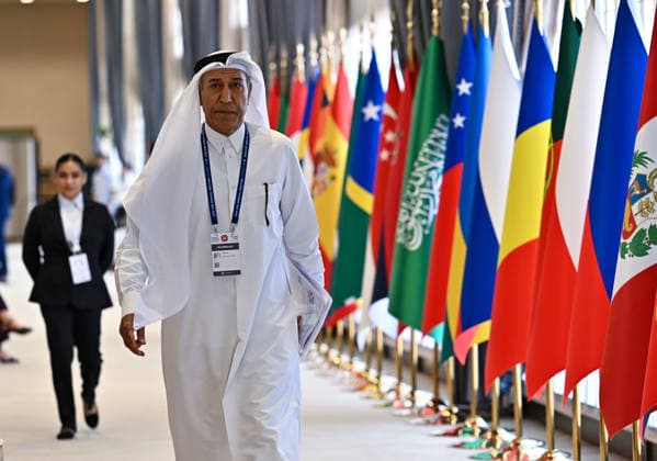 Opening ceremony of the 11th annual meeting of the Asian Infrastructure Investment Bank (AIIB) in Doha A participant walks past flags during the 11th Annual Meeting of the Board of Governors of the Asian Infrastructure Investment Bank (AIIB) in Doha,Qatar on September 28, 2026 DOHA Qatar Copyright: xNOUSHADx