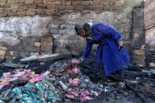 Olha Shylimina, head of the Loving Hearts animal shelter, examines the charred remains of pet food at the shelter’s destroyed main building in the Odesa region, Ukraine, September 29, 2026. During a nighttime Russian drone strike, the roof of the building - covering more than 400 square metres - was hit. The fire destroyed the premises along with stocks of grain, medicines, warm blankets, bowls, and other critical supplies. Thirteen animals - 10 cats and three dogs - died as a result of the strike and ensuing fire. (Photo by Nina Liashonok Ukrinform) Russia strikes animal shelter near Odesa  Copyright: xNinaxLiashonokx