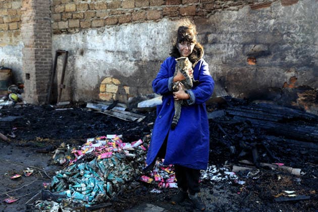 Olha Shylimina, head of the Loving Hearts animal shelter, holds a rescued cat against the backdrop of the scorched stone walls of the shelter’s destroyed main building in the Odesa region, Ukraine, September 29, 2026. During a nighttime Russian drone strike, the roof of the building - covering more than 400 square metres - was hit. The fire destroyed the premises along with stocks of grain, medicines, warm blankets, bowls, and other critical supplies. Thirteen animals - 10 cats and three dogs - died as a result of the strike and ensuing fire. (Photo by Nina Liashonok Ukrinform) Russia strikes animal shelter near Odesa  Copyright: xNinaxLiashonokx