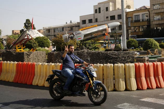 Ballistic missiles and unmanned aerial vehicles displayed in Tehran TEHRAN, IRAN - SEPTEMBER 29: ( RESTRICTIONS: NO Access Israel Media Persian Language TV Stations Outside Iran Strictly No Access BBC Persian VOA Persian Manoto TV Iran International TV ) A man riding a motobike poses for photos as ballistic missiles, air defense systems and unmanned aerial vehicles are displayed at Baharestan Square as part of Iran s Sacred Defense Week amid ongoing tensions in Tehran, Iran, on September 29, 2026. Fatemeh Bahrami Anadolu Tehran Iran. Editorial use only. Please get in touch for any other usage.  Copyright: x2026xAnadoluxFatemehxBahramix