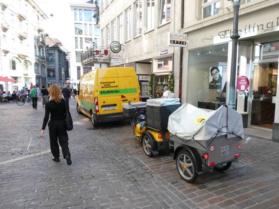 September 29, 2026, Switzerland: Photo of mail delivery using 100 percent electric delivery vans and an electric three-wheeled scooter
