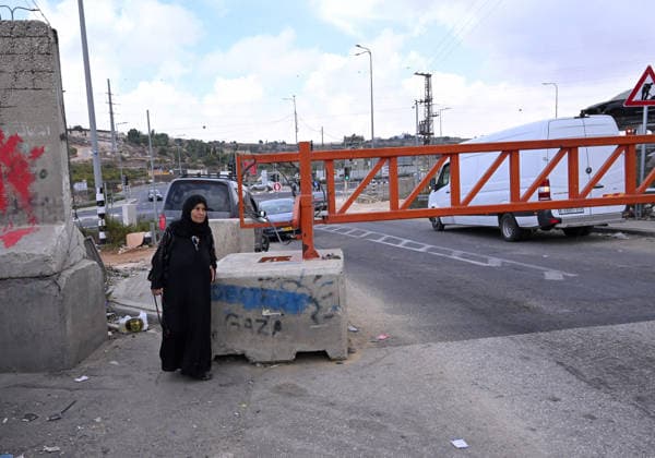 An elderly Palestinian walks past an Israeli erected locked gate that blocks cars from moving to and from the village of Khirbat Zayta, near Hebron in the West Bank, on Tuesday, September 29, 2026. Israel declared a West Bank military closure to restrict Palestinian movement during the Jewish holiday of Sukkot from September 27 - October 3, 2026.  JER2026092904 DEBBIExHILL