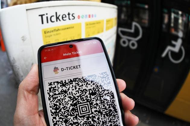Berlin, Germany, September 30, 2026: A person is holding a smartphone displaying the QR code for the Deutschlandticket at a bus stop Copyright: xdtsxNachrichtenagenturx dts_136840