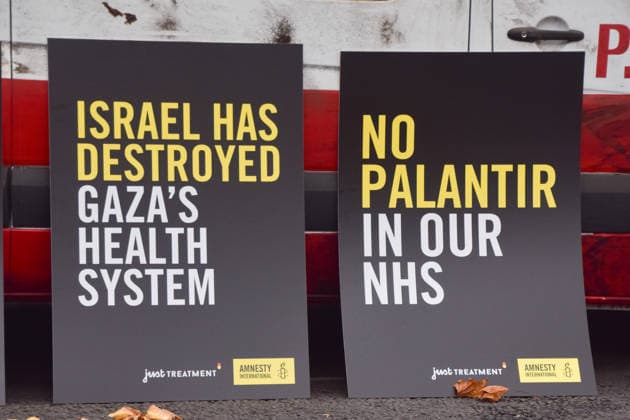 September 30, 2026, London, England, United Kingdom: Placards are placed against a van made to look like a heavily damaged Gaza ambulance parked outside Palantir headquarters in Soho Square as Amnesty International UK and Just Treatment stage a protest calling on the UK Government not to extend its NHS contract with the US tech company. London United Kingdom - ZUMAv130 20260930_zip_v130_016 Copyright: xVukxValcicx