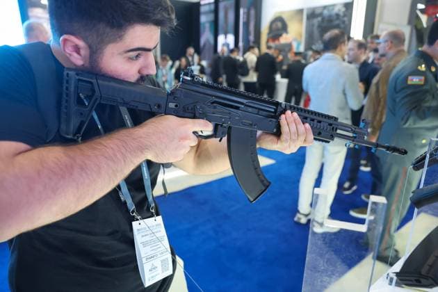 30.09.2026. Azerbaijan. Baku. A visitor inspects a Kalashnikov assault rifle presented at the stand of the Kalashnikov Concern at the Azerbaijan International Defense Industry Exhibition ADEX 2026. Alexey Belkin NEWS.ru BelkinxAlexey