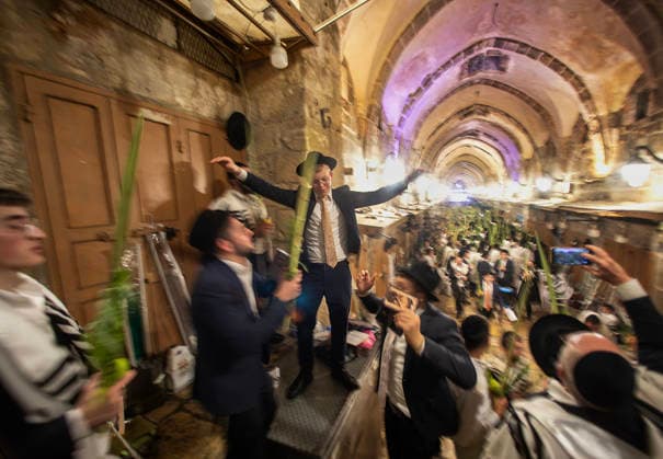 An ultra-Orthodox Jewish man dances during a mass prayer service during the Holy Week of Sukkot, or the Feast of Tabernacles, held in the Moslem Quarter in Jerusalem on Wednesday, September 30. 2026. Thousands of Jews, mostly ultra-Orthodox, packed a street leading to a gate, which was closed, leading into the Temple Mount or the á¸¤aram al Sharif where the Al Aqsa Mosque is located.  JER20260930010 JimxHollander
