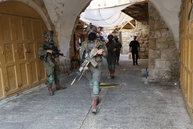 September 30, 2026, Hebron, Palestine, State of: HEBRON, OCCUPIED WEST BANK, SEPTEMBER 30, 2026: Israeli settlers walk through Hebron s Old City under the protection of Israeli forces during celebrations for the Jewish holiday of Sukkot. Israeli forces maintained heightened security measures and movement restrictions around the Old City and the Ibrahimi Mosque during the holiday period. Hebron Palestine, State of  - ZUMAq101 20260930_zna_q101_114 Copyright: xMosabxShawerx