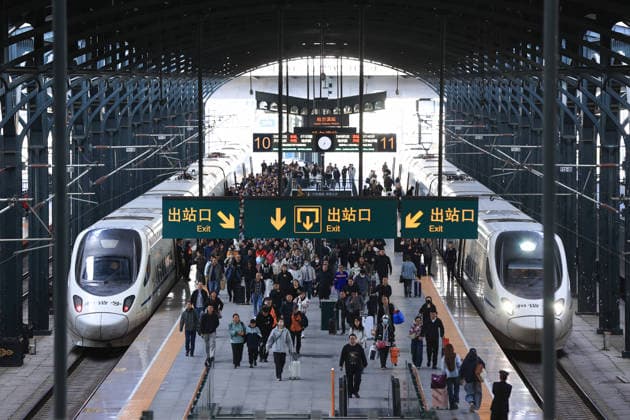 (261001) -- BEIJING, Oct. 1, 2026 -- Passengers walk out of the Harbin Railway Station in Harbin, northeast China s Heilongjiang Province, Oct. 1, 2026. The transportation network of the country witnessed a travel peak on the first day of the National Day holiday. (Photo by Xinhua) CHINA-NATIONAL DAY HOLIDAY-TRAVEL PEAK (CN) XuxShuai 
