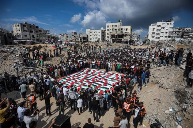 Palestinians Hold Mass Funeral for 105 Recovered from Gaza Rubble Palestinians take part in a mass funeral for 105 Palestinians whose remains were recovered from beneath the rubble of destroyed buildings in the al-Taj area of Gaza City’s al-Yarmouk neighborhood on October 1, 2026. The victims, including women and children, were killed in Israeli airstrikes during the early stages of the war, with families gathering for their funeral and burial after their remains had been trapped under the rubble for years. Photo by Bilal Osama apaimages Gaza city Gaza Strip Palestinian Territory 011026_Gaza_BO_00(11) Copyright: xapaimagesxBilalxOsamax xapaimagesx