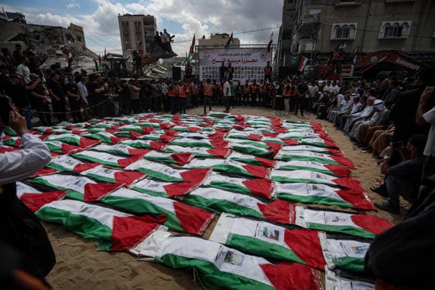 Palestinians Hold Mass Funeral for 105 Recovered from Gaza Rubble Palestinians take part in a mass funeral for 105 Palestinians whose remains were recovered from beneath the rubble of destroyed buildings in the al-Taj area of Gaza City’s al-Yarmouk neighborhood on October 1, 2026. The victims, including women and children, were killed in Israeli airstrikes during the early stages of the war, with families gathering for their funeral and burial after their remains had been trapped under the rubble for years. Photo by Bilal Osama apaimages Gaza city Gaza Strip Palestinian Territory 011026_Gaza_BO_00(7) Copyright: xapaimagesxBilalxOsamax xapaimagesx