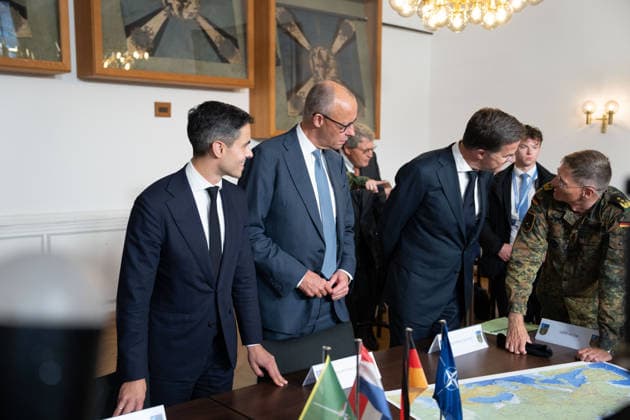 Visit to the German-Dutch Corps by Federal Chancellor Merz and Rob Jetten, Prime Minister of the Netherlands, together with Federal Chancellor Friedrich Merz, NATO Secretary General Mark Ruette listen intently to the remarks by Lieutenant General Peter Mirow, who is holding a map of Europe during a visit to the 1st German-Dutch Corps, Münster, October 1, 2026, Münste